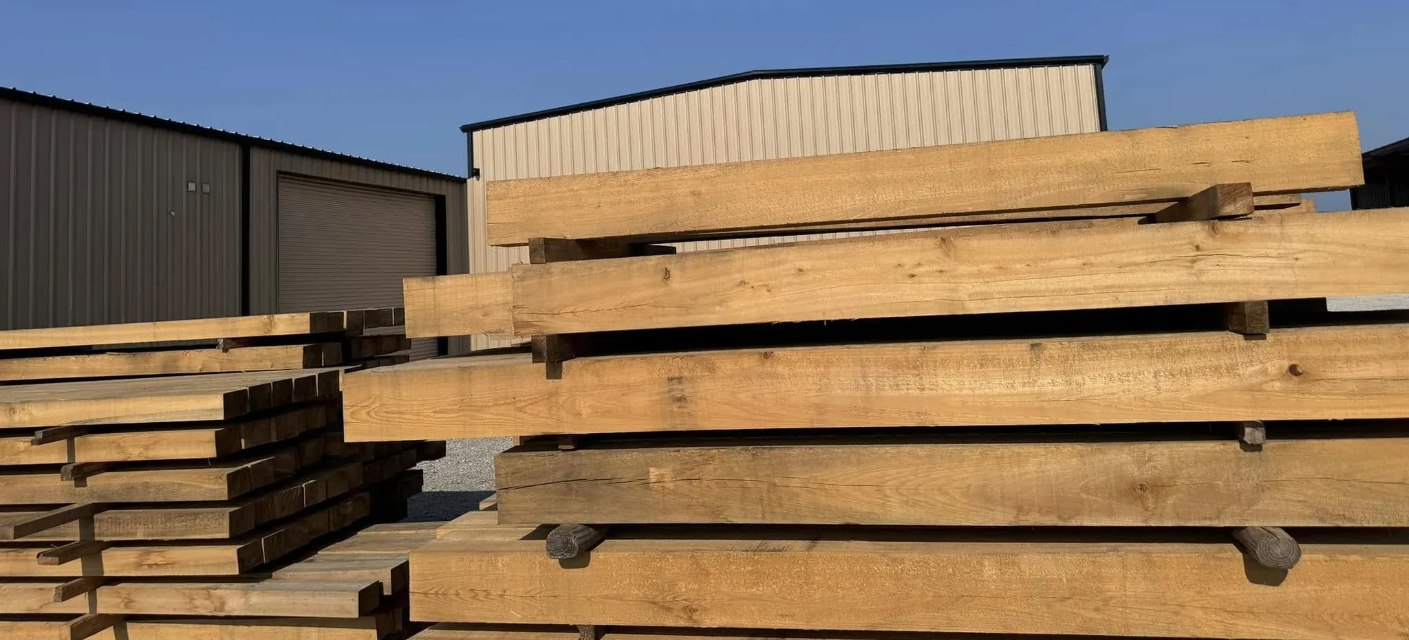 Beams stacked in the yard behind the mill on Industrial Boulevard