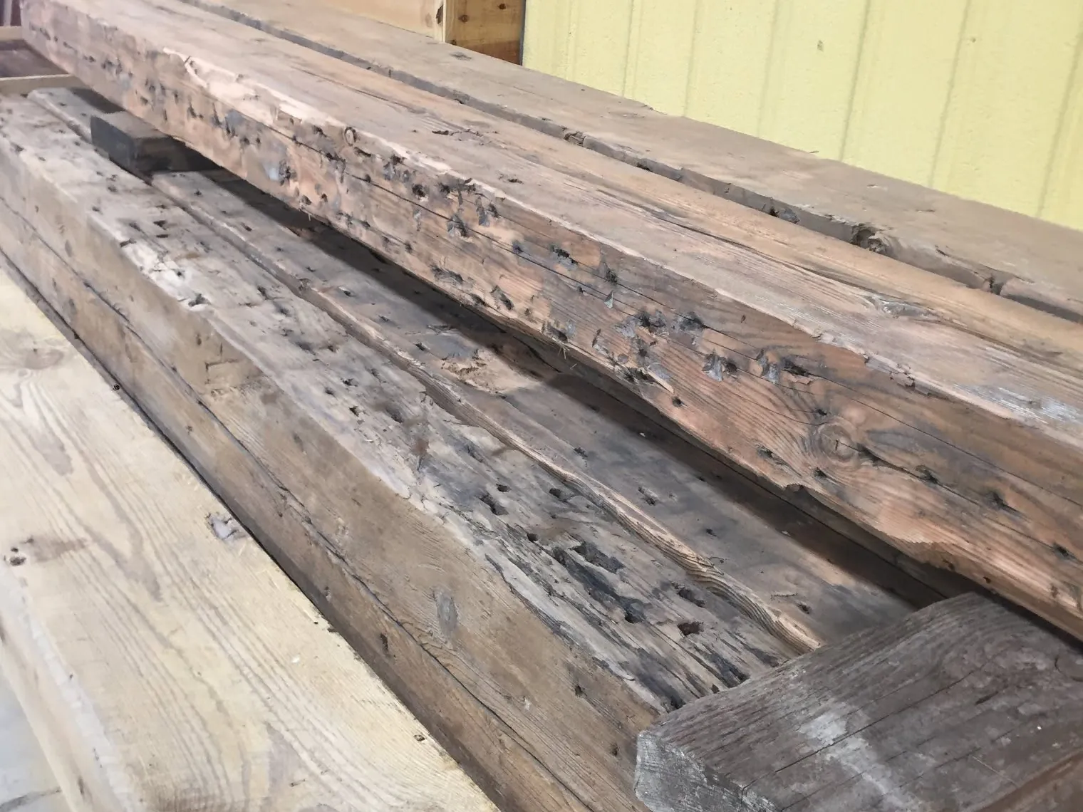 An order of antique reclaimed beams staged to ship