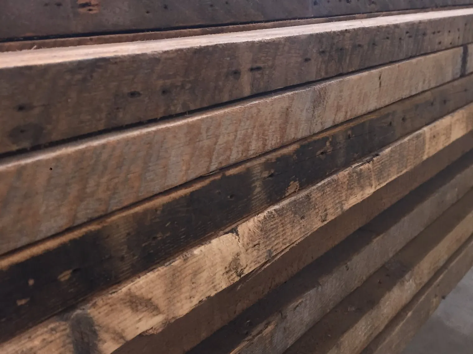Weathered reclaimed timbers stacked in the shop